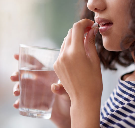 Girl Taking Pill